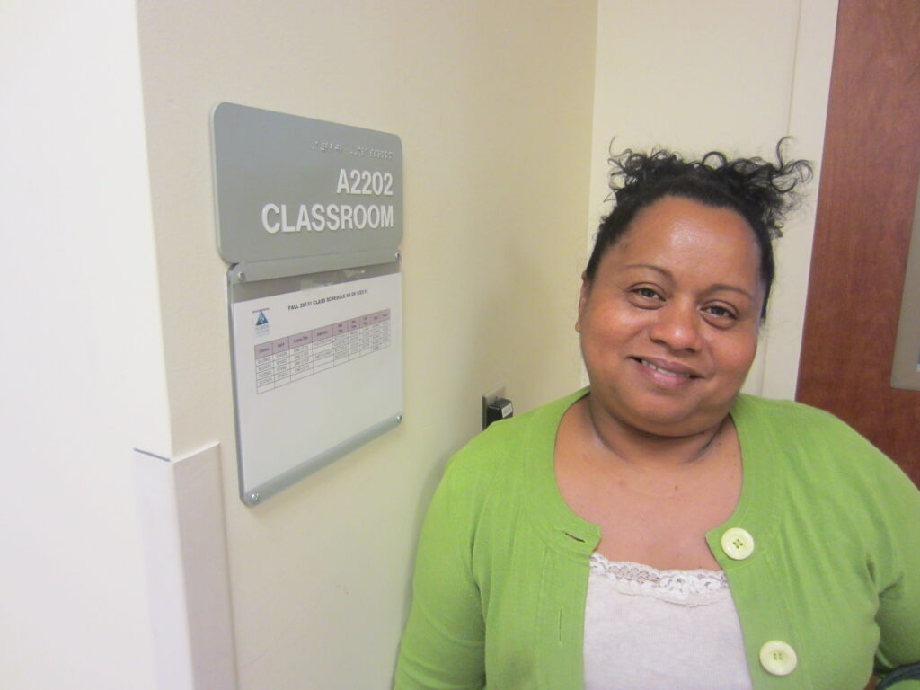 Lourdes in 2013 stands outside the college classroom in Jacksonville, Florida, where she studies four nights a week in her quest to earn a GED. [Credit: Sonia Nazario]