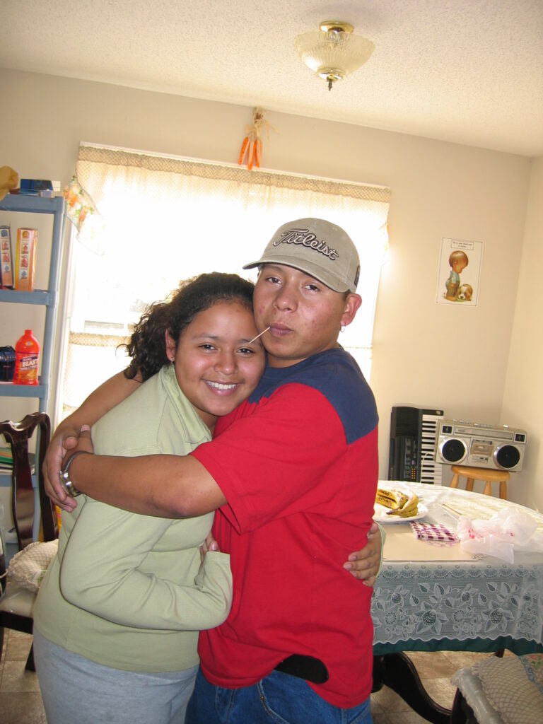 Enrique and sister Diana share a hug, 2003. [Credit: Sonia Nazario]